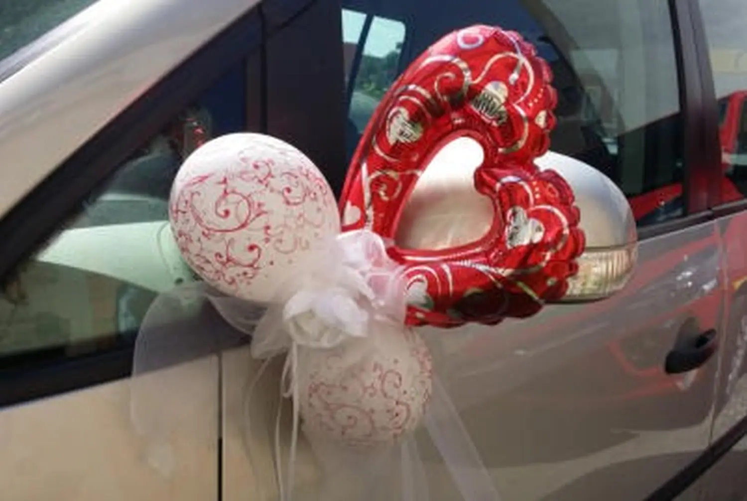 Ballon Moments - Dekoration - Rot-weiße Herzluftballons am Hochzeitsauto