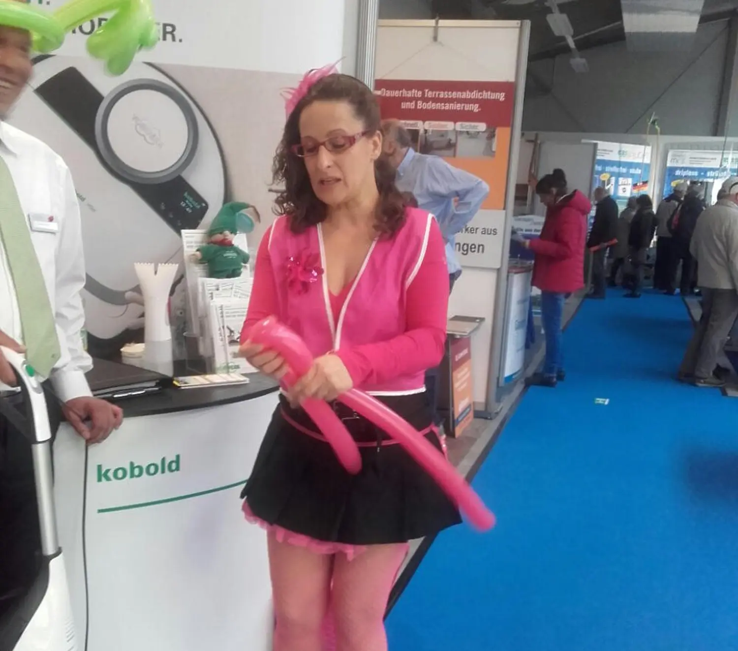 Moments Veranstaltungsagentur - Frau formt pinke Luftballonfigur