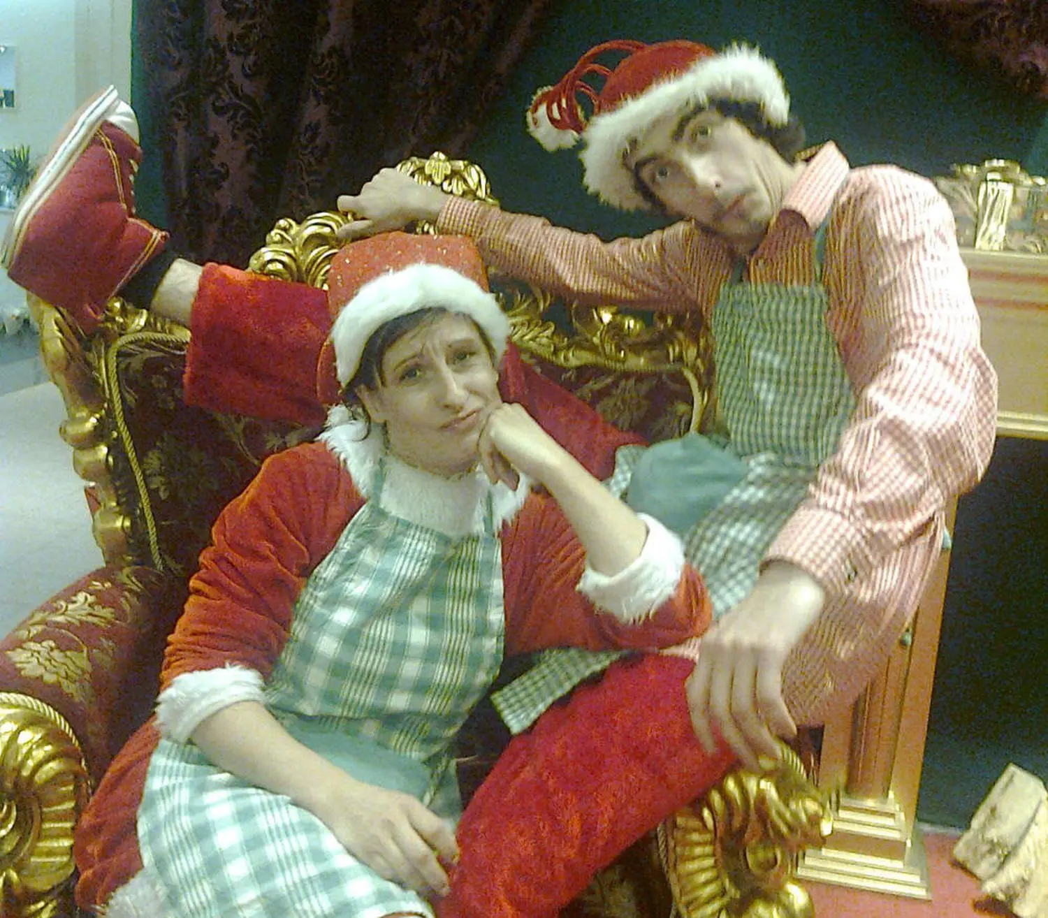 Moments Veranstaltungsagentur -  Zwei Personen in Weihnachtskostümen auf rotem Sofa