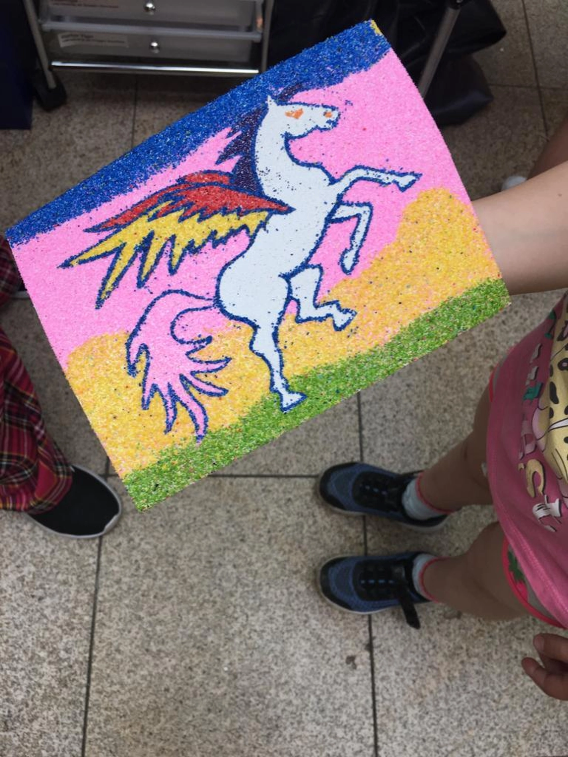 Moments Veranstaltungsagentur -Sandbild mit Einhorn-Motiv